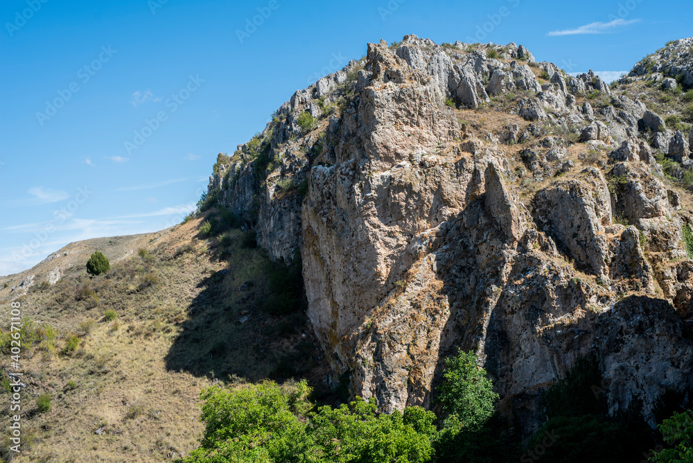 Arroyo Boqueron, Valle de Tabladillo, Segovia. limestone rock mountain with green trees