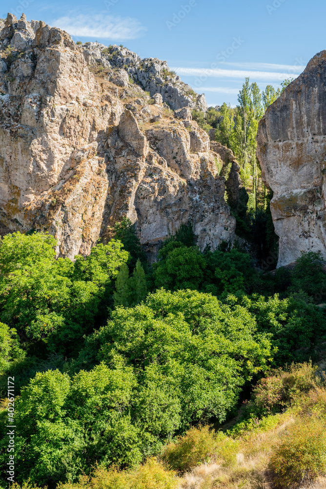 Arroyo Boqueron, Valle de Tabladillo, Segovia. limestone rock mountain with green trees Arroyo Boqueron, Valle de Tabladillo, Segovia. limestone rock mountain with green trees