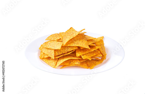 mexican nachos chips on a ceramic plate isolated on a white background.