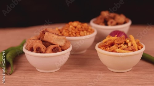 shing bhujia and chanadal with bhakharvadi on wooden table,Indian Namkeen indian food in white bowl in white background,Namkeen in a bowl wooden background, photo