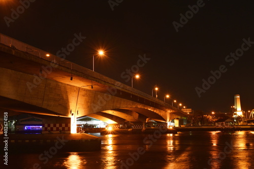 landscape of Phra Pok Klao memorial bridge cross river in Thailand cn night