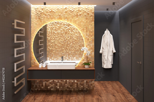 Stampa su tela Luxury dark bathroom with an overhead washbasin on a wooden cabinet near a large round mirror on a gold mosaic wall, a door, a heated towel rail, a bathrobe, black walls, a wooden floor