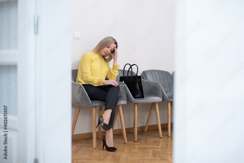 Pensive woman waiting for job interview indoors.