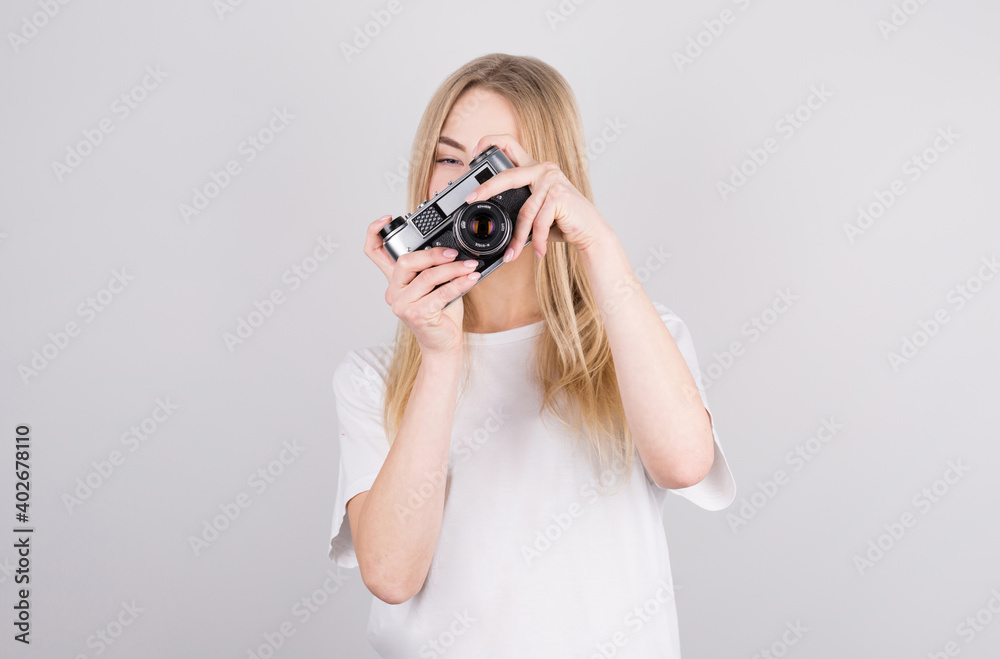 Happy smiling young girl holding camera and taking photos Happy smiling young girl holding camera and taking photos
