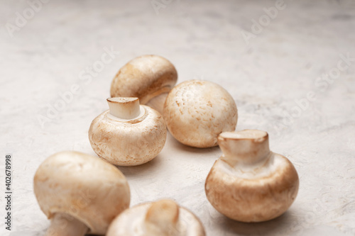 A few mushrooms on a light stone table