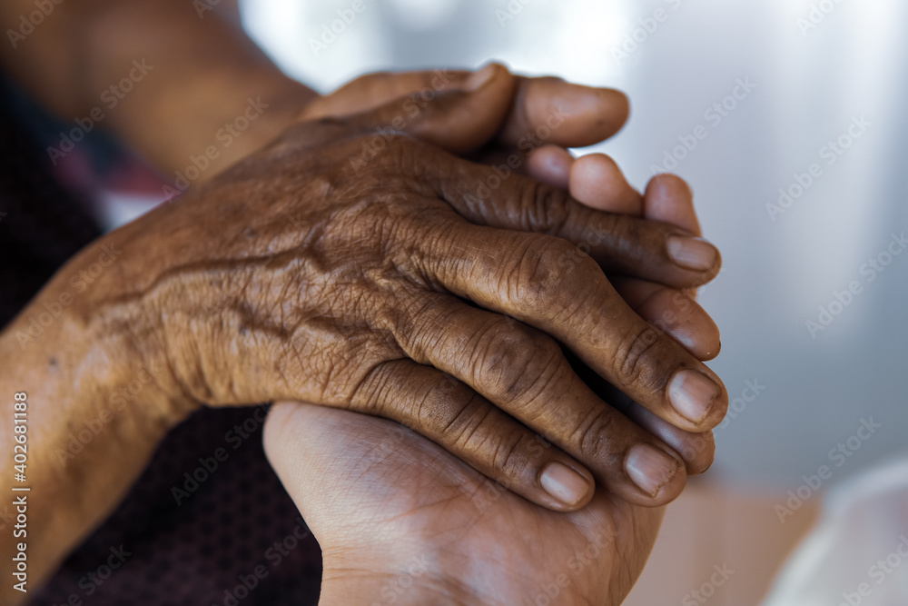 Fototapeta premium people holding hand of mother elderly that is Alzheimer and Parkinson patient.
