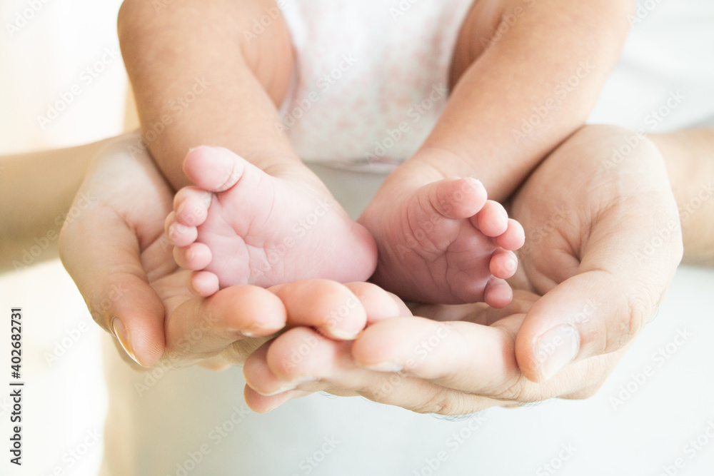 Parents hold their baby feet on their hands. Happy family concept. Parents hold their baby feet on their hands. Happy family concept.