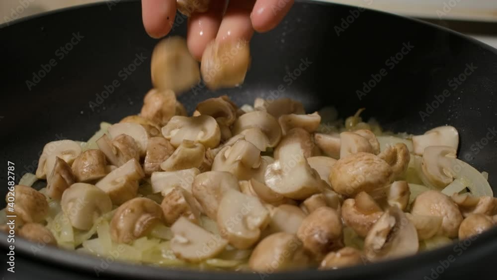 Slow Motion Man Frying Mushrooms with Onions in Olive Oil Into Frying Pan, Close Up. Macro Shot. Chef Frying Mushrooms with Onions in Vegetable Oil to Frying Pan for Cooking Dish. Slow Motion Cooking Slow Motion Man Frying Mushrooms with Onions in Olive Oil Into Frying Pan, Close Up. Macro Shot. Chef Frying Mushrooms with Onions in Vegetable Oil to Frying Pan for Cooking Dish. Slow Motion Cooking
