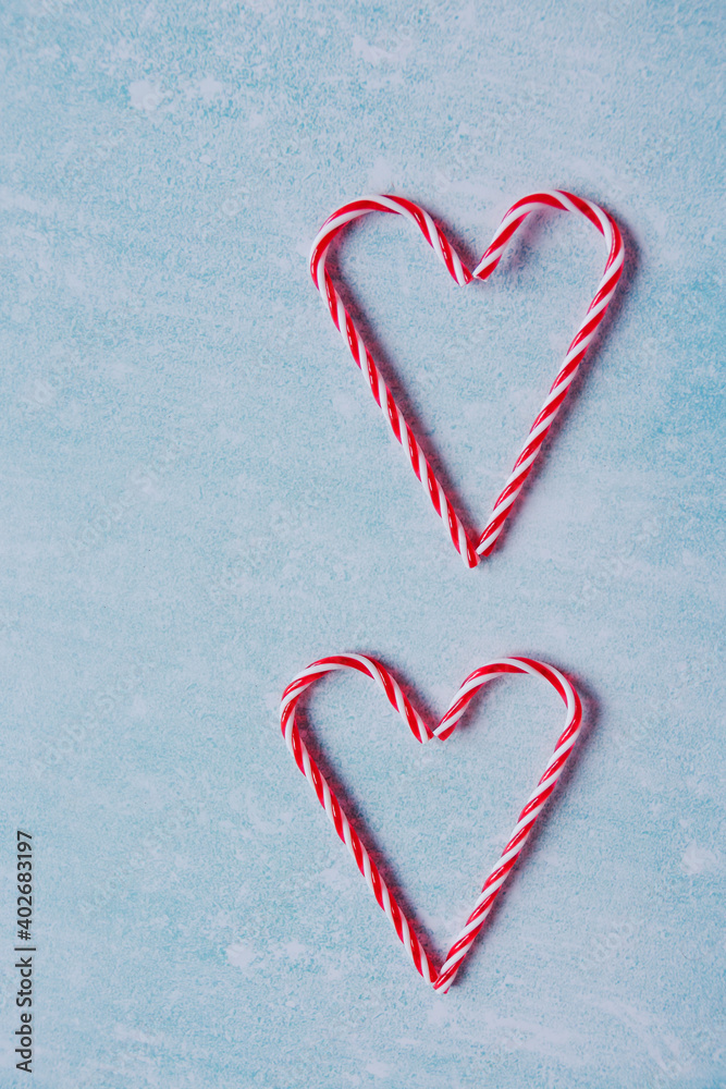Festive blue background. Heart of sweet candies. Christmas card. Valentine Day. 14 of February. Flat lay, top view.