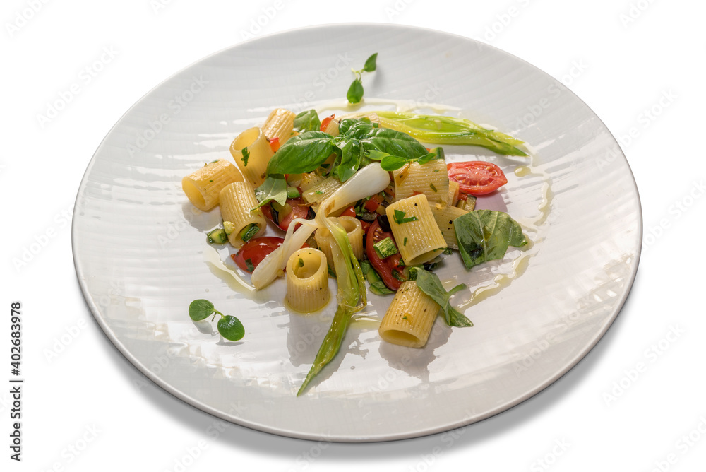 Half striped paccheri with tomatoes, basil and spring onion. Pasta macaroni italian cooked seasoned in white plate isolated on white background Half striped paccheri with tomatoes, basil and spring onion. Pasta macaroni italian cooked seasoned in white plate isolated on white background
