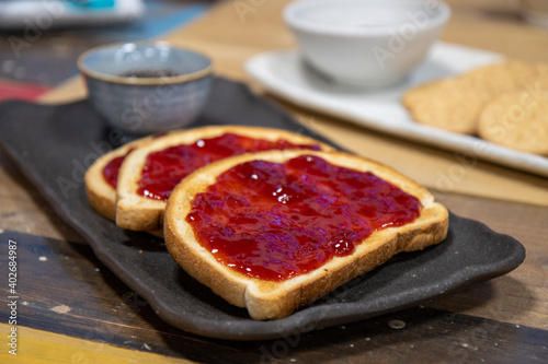 A plate of delicious jam on toast at breakfast time in a kitchen