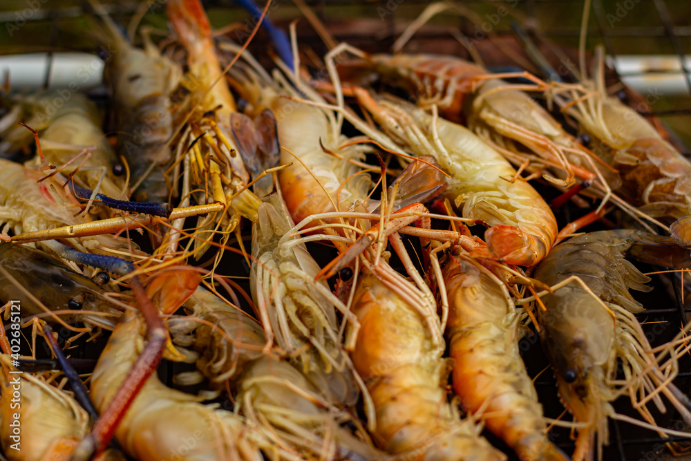 The grilled shrimp on the stove are about to be ready to eat. The grilled shrimp on the stove are about to be ready to eat.