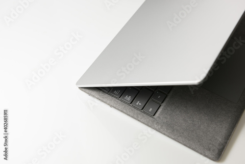 Close-up top view of laptop in platinum silver color on white background photo