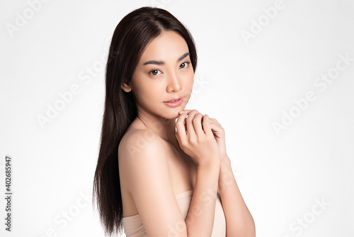 Beautiful Young asian Woman with Clean Fresh Skin, on Pink background, Face care, Facial treatment. Cosmetology, beauty and spa. Asian women portrait