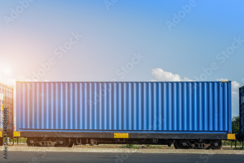 Freight Train with Cargo Containers, Transport, Shipping import Export on blue sky background