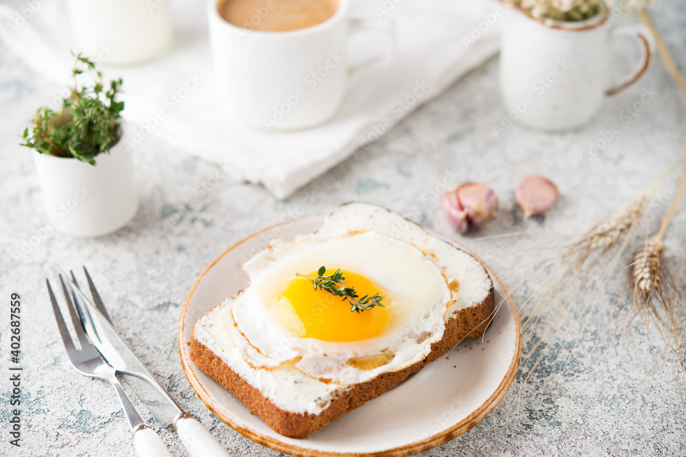 Breakfast of toast with fried egg on a plate, selective