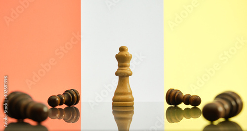 Success and victory concept. Queen being the last chess piece standing, surrounded by black fallen pawns