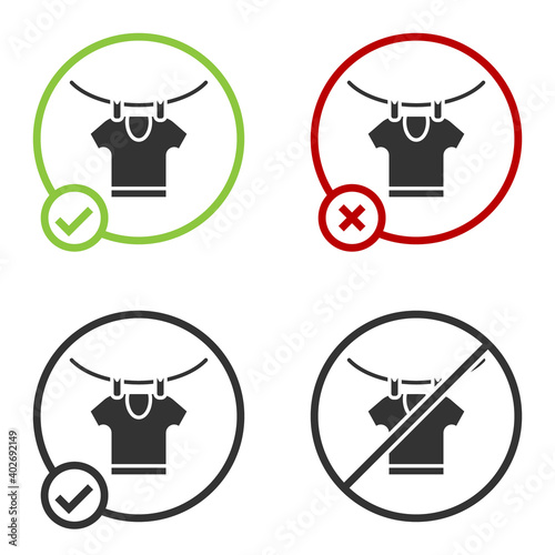 Black Drying clothes icon isolated on white background. Clean shirt. Wash clothes on a rope with clothespins. Clothing care and tidiness. Circle button. Vector.