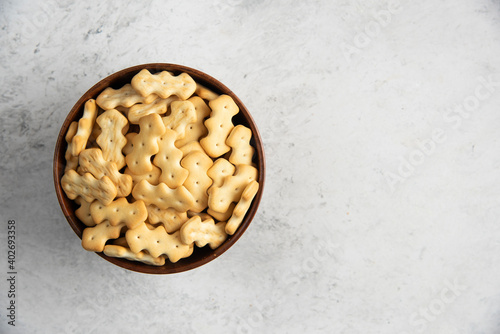 A wooden bowl full of delicious crackers photo