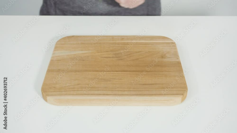 Step by step. Shredding organic cabbage on a wood cutting board. Step by step. Shredding organic cabbage on a wood cutting board.