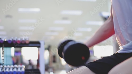 Closeup of young athlete Man exercising with dumbbell in fitness studio ,Lose weight