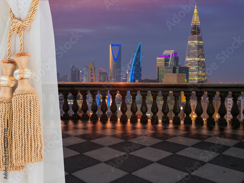 A view of Riyadh city, Saudi Arabia from a terrace (balcony) of a high building from inside the room showing a beautiful curtain.