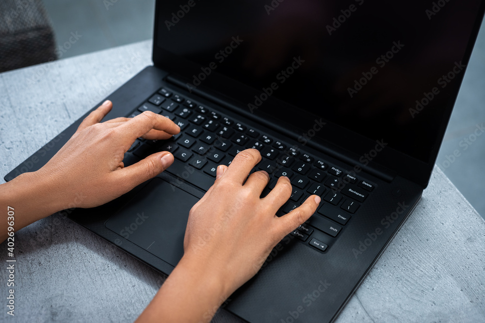 View of a woman's hands typing on a laptop. Remote work from home. View of a woman's hands typing on a laptop. Remote work from home.