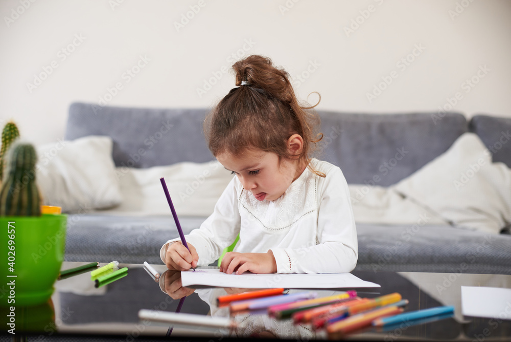 Beautiful preschool girl focused on drawing. Concept of preschool education at home. Beautiful preschool girl focused on drawing. Concept of preschool education at home.
