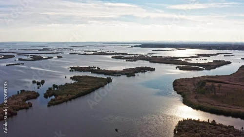 Bird's-eye view of the beautiful Samarskie Plavni in the warm evening light in Ukraine. Aerial UHD 4K drone realtime video, shot in 10bit HLG and colorized