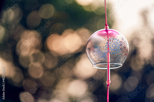 Japanese traditional wind bell or furin chimes symbol of summer on bokeh background photo