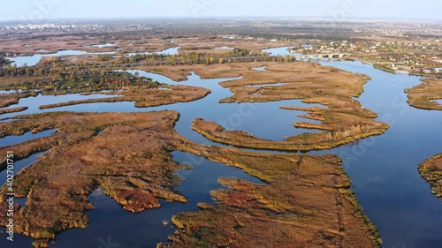 Aerial view of the Samarskie Plavni on the Dnieper in Ukraine in the evening warm bright light. Aerial UHD 4K drone realtime video, shot in 10bit HLG and colorized photo