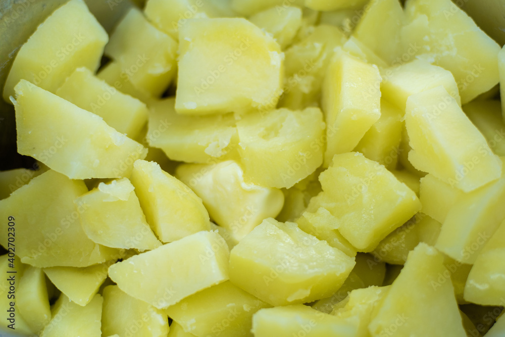 Boiled potatoes in pieces in a saucepan with butter. Boiled potatoes in pieces in a saucepan with butter.