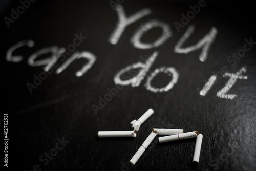 Quit smoking. You can do it- inscription on a black background.