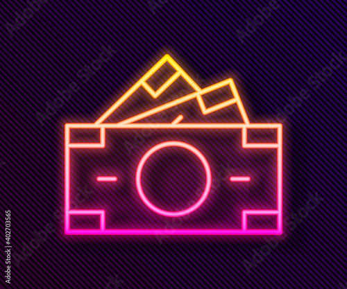 Glowing neon line Stacks paper money cash icon isolated on black background. Money banknotes stacks. Bill currency. Vector.