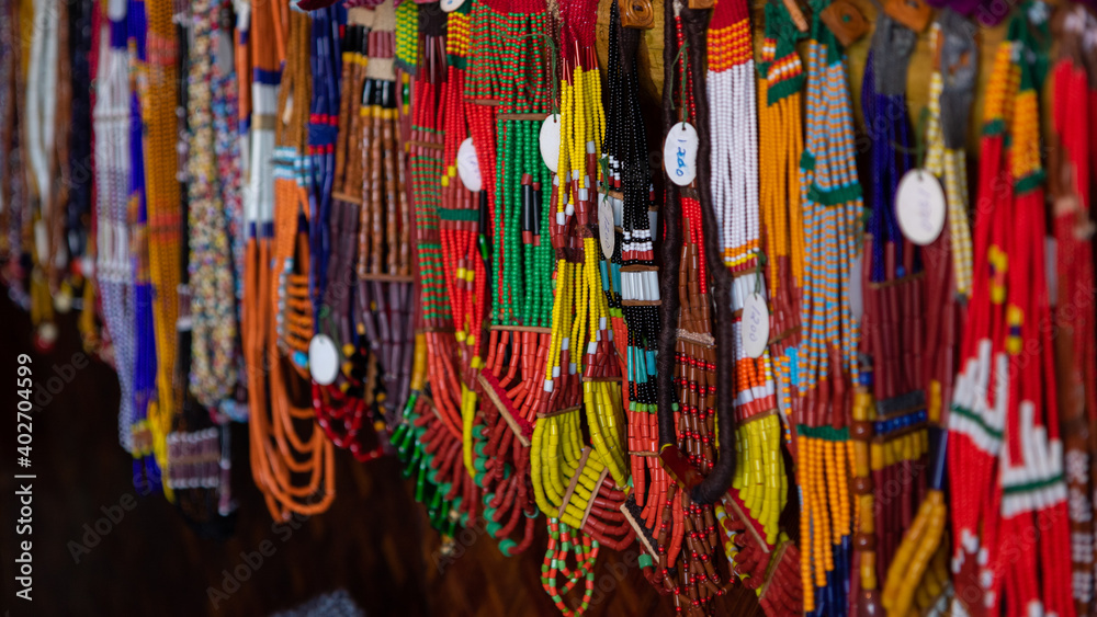 Selective focus with shallow depth of field image of colorful beads and various designs hanging
