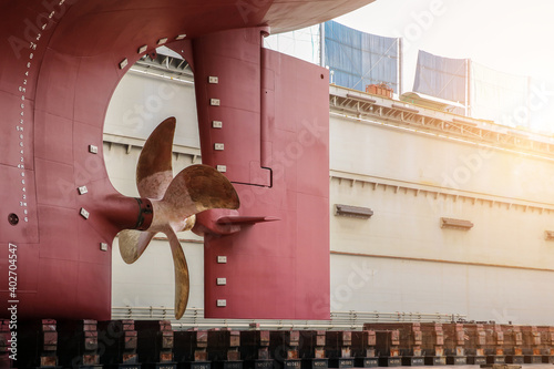 Vessel stern and propeller, rudder and shaft maintenance on sleeper in floating dock in shipyard