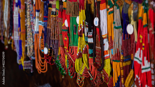 Selective focus with shallow depth of field image of colorful beads and various designs hanging 
