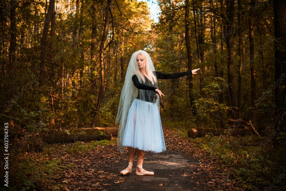 Young ballerina in ballet costume dancing in city park, feeling breath of big city life and freedom Young ballerina in ballet costume dancing in city park, feeling breath of big city life and freedom