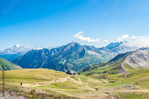 Billede på lærred Mountain ranges and a refuge observed across meadows on the Col de la Croix, Tou
