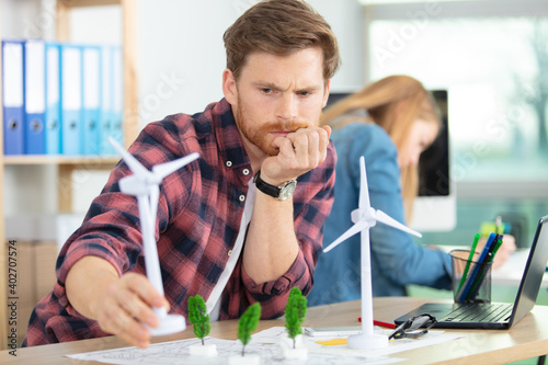 male architect studying plans in office