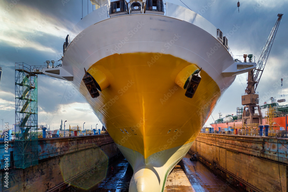big yellow roro vessel inside a dry dock for repair Stock Photo | Adobe ...