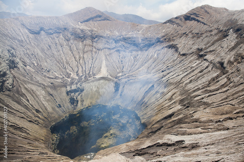 Crater with active volcano smoke in East Jawa, Indonesia. Aerial view of volcano crater Mount Gunung Bromo is an active volcano