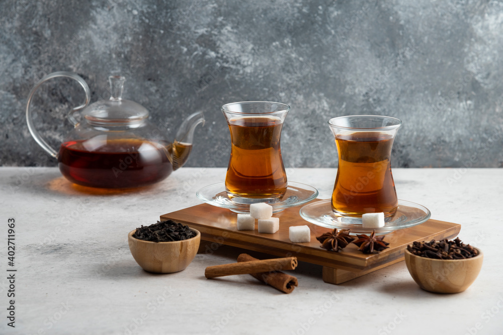 Two glasses cup of tea with sugar and star anise