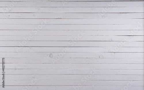 Old white planks. The 5-centimeter planks are lined up next to each other.