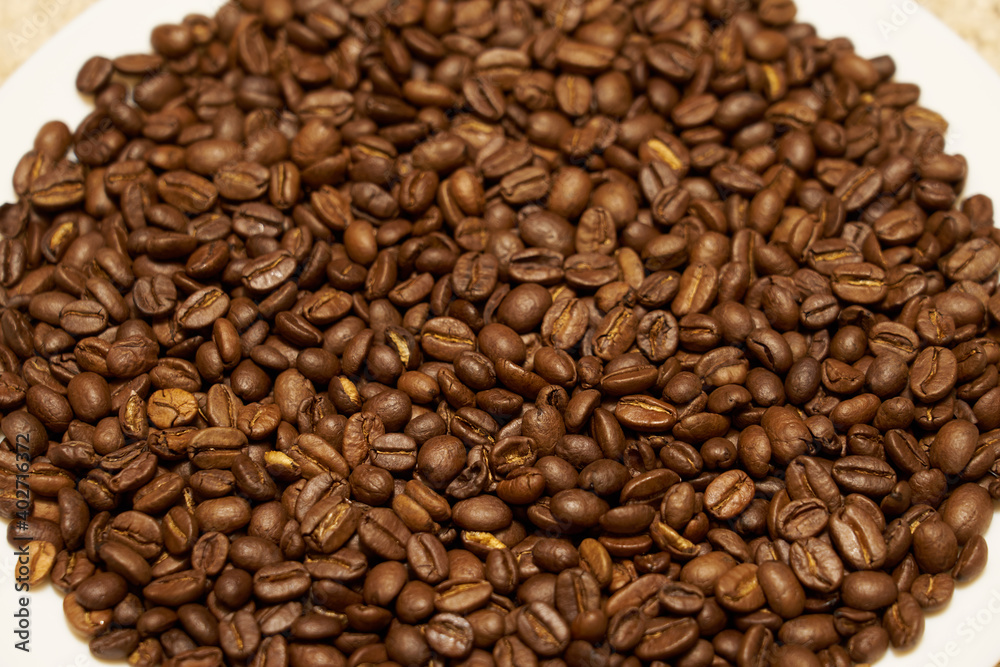 Roasted coffee beans as a background. Kitchen concept. Roasted coffee beans as a background. Kitchen concept.