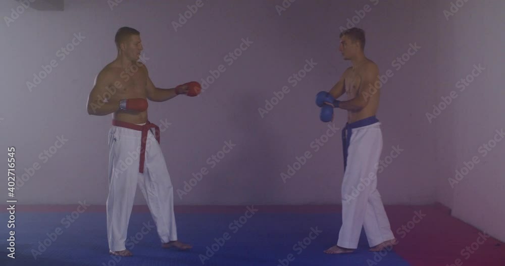 Karate men practicing inside a gym Karate men practicing inside a gym