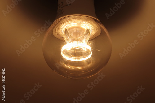 Close-up of light bulb with burning wire visible