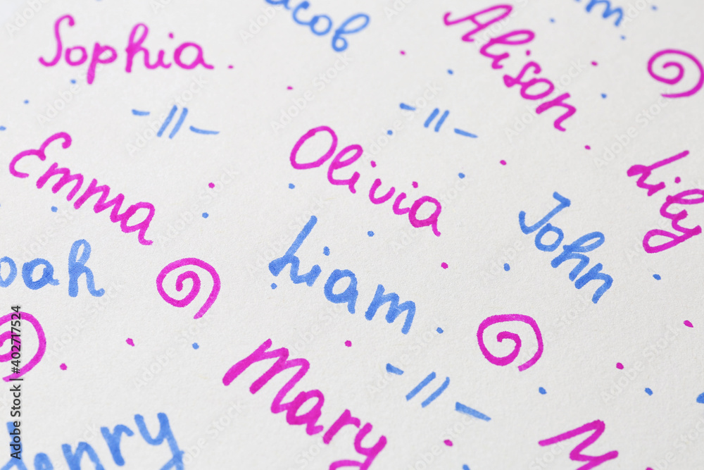 Different baby names written on paper, above view Different baby names written on paper, above view