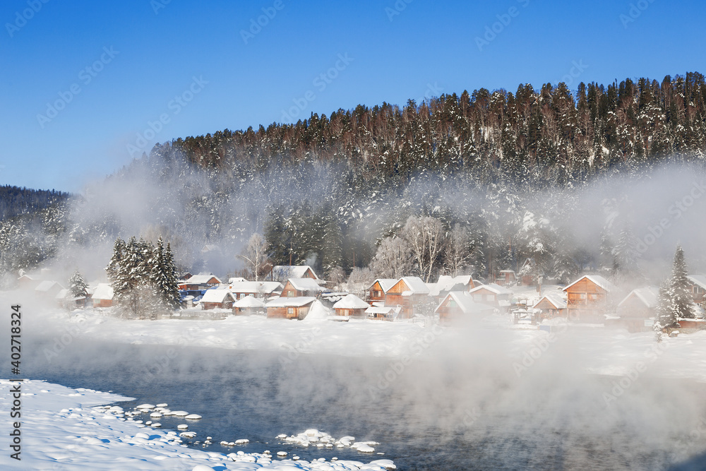 View of the winter Altai with the Biya river, Artybash village and mountains on the horizon. Altai Republic, Russia View of the winter Altai with the Biya river, Artybash village and mountains on the horizon. Altai Republic, Russia