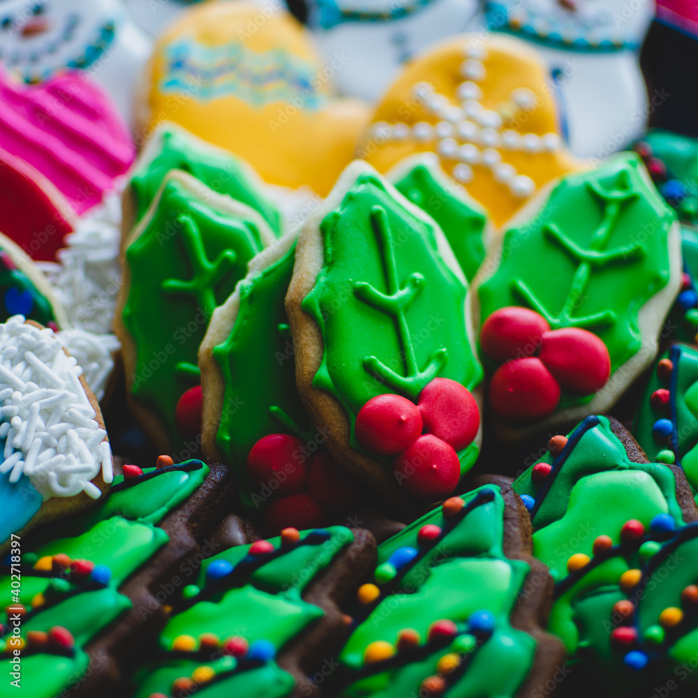 A platter of beautifully decorated bright colorful Christmas cookies